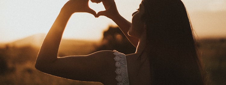 woman forming heart with her both hands